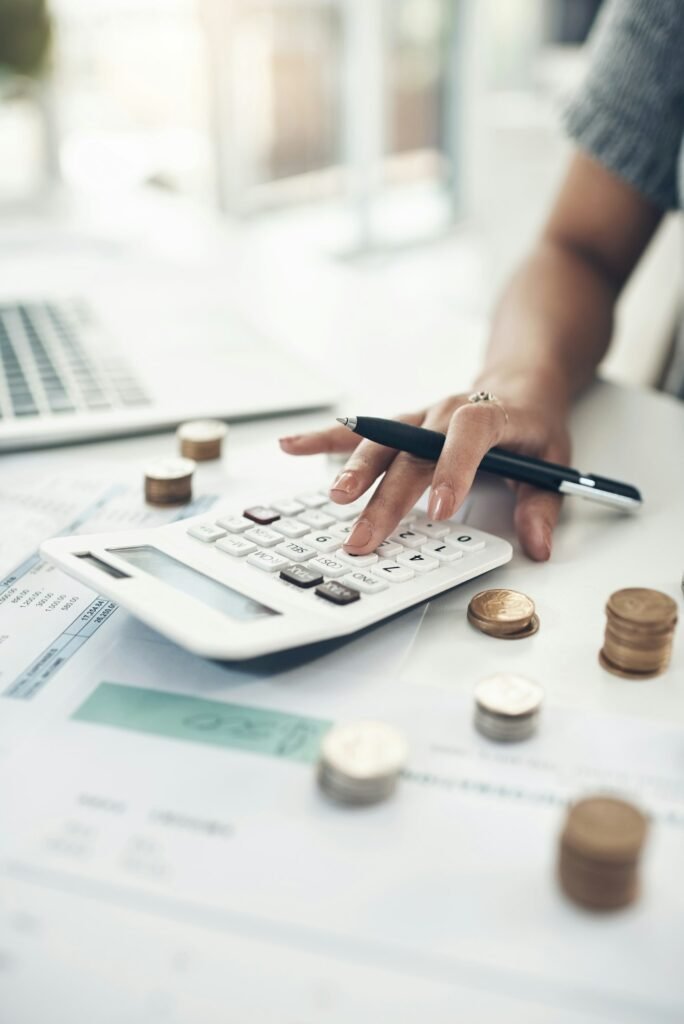 Closeup shot of an unrecognisable businesswoman calculating finances in an office